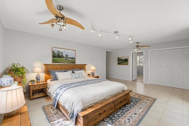 bedroom featuring light tile patterned flooring, ceiling fan, and a closet