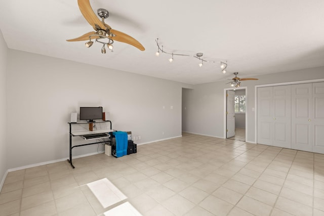 spare room with ceiling fan and baseboards