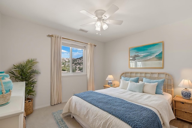 carpeted bedroom featuring a ceiling fan and baseboards