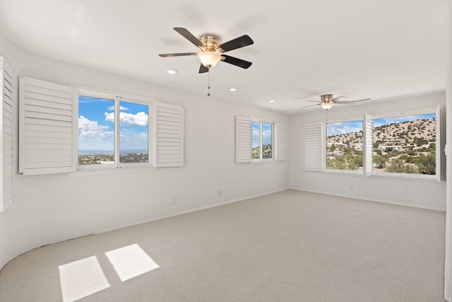 carpeted empty room featuring a ceiling fan, recessed lighting, and baseboards