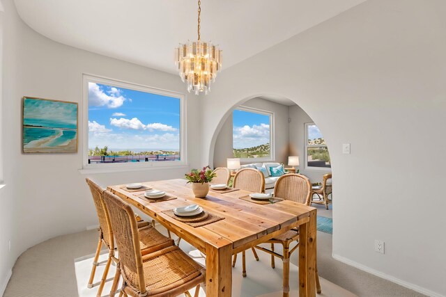 115 Camino De Las Huertas, Placitas, NM 87043 - spare room featuring a chandelier, carpet, and arched walkways