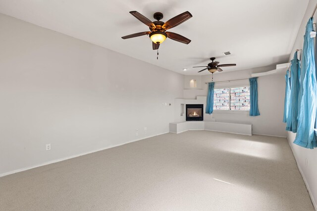 115 Camino De Las Huertas, Placitas, NM 87043 - empty room featuring a ceiling fan, arched walkways, and light colored carpet
