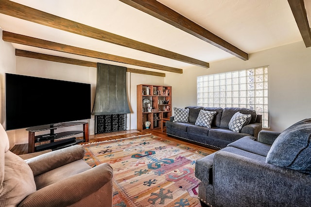 living area featuring beam ceiling and wood finished floors