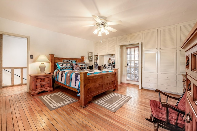 bedroom with light wood finished floors, access to outside, and ceiling fan