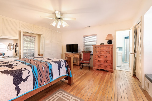 bedroom with visible vents, ceiling fan, multiple windows, and light wood-style floors