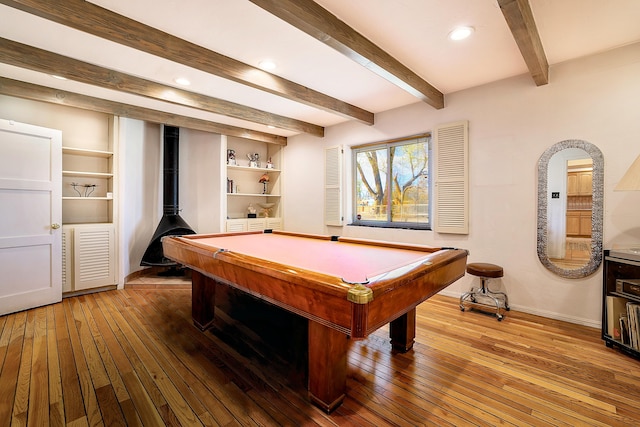 recreation room featuring hardwood / wood-style flooring, baseboards, a wood stove, and pool table