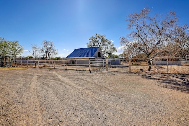 view of yard with a rural view, an outbuilding, and an exterior structure