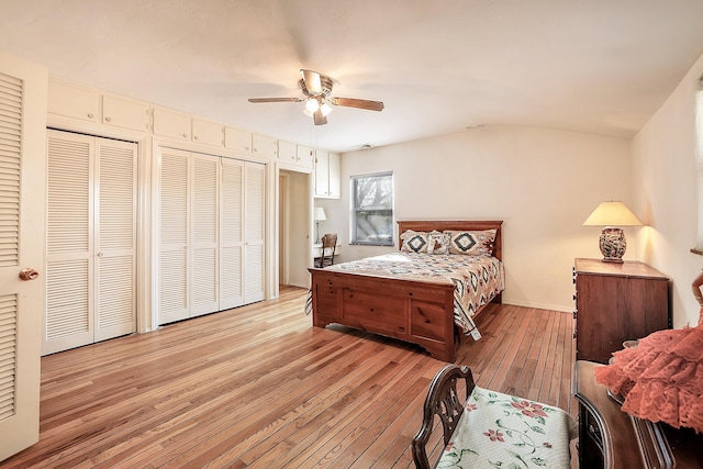 bedroom with light wood finished floors, baseboards, a ceiling fan, and lofted ceiling