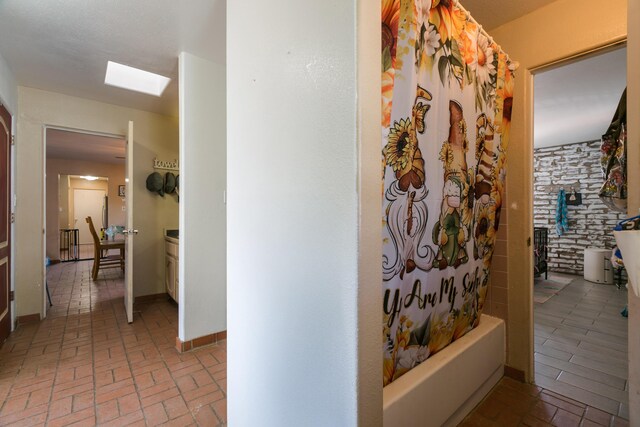 32 Puntilla Dr Unit B, Tijeras, NM 87059 - full bathroom with shower / bath combination with curtain, a skylight, and brick floor