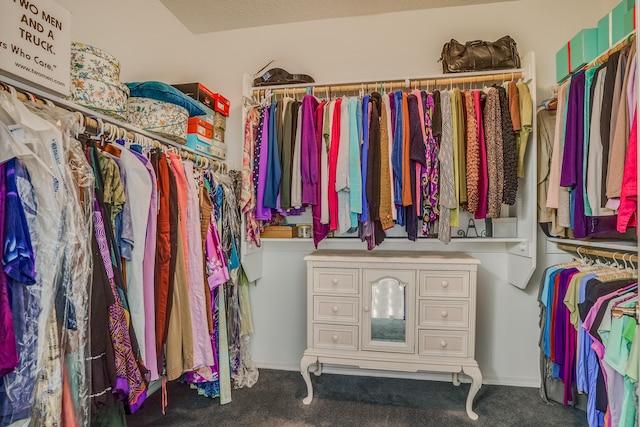 walk in closet with carpet flooring