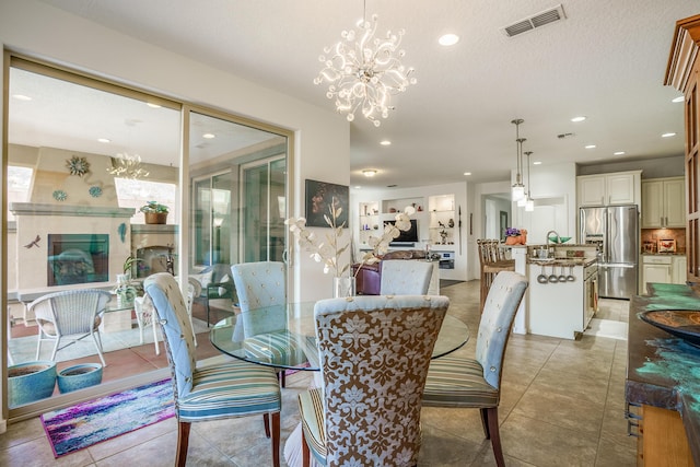 dining area featuring visible vents, light tile patterned floors, an inviting chandelier, a textured ceiling, and recessed lighting