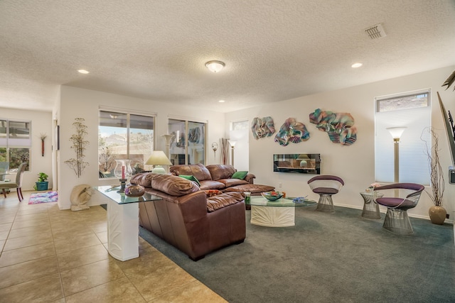 tiled living area featuring visible vents, recessed lighting, and a textured ceiling