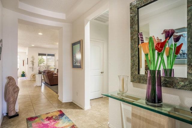 corridor with light tile patterned floors, baseboards, visible vents, and recessed lighting