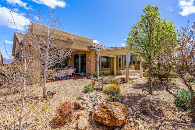 back of house with a patio, a pergola, and a tile roof