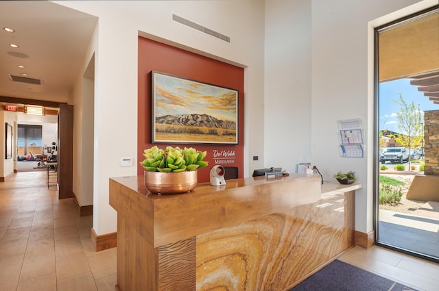 bar featuring visible vents, a wealth of natural light, and tile patterned floors