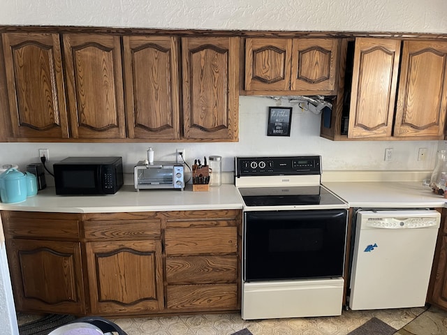12900 Piru Blvd SE, Albuquerque, NM 87123 - kitchen with black microwave, electric range oven, dishwasher, and light countertops