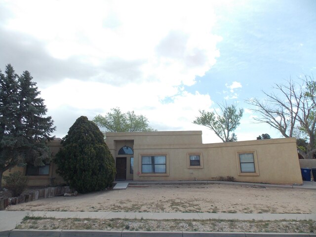 12900 Piru Blvd SE, Albuquerque, NM 87123 - pueblo-style home with stucco siding
