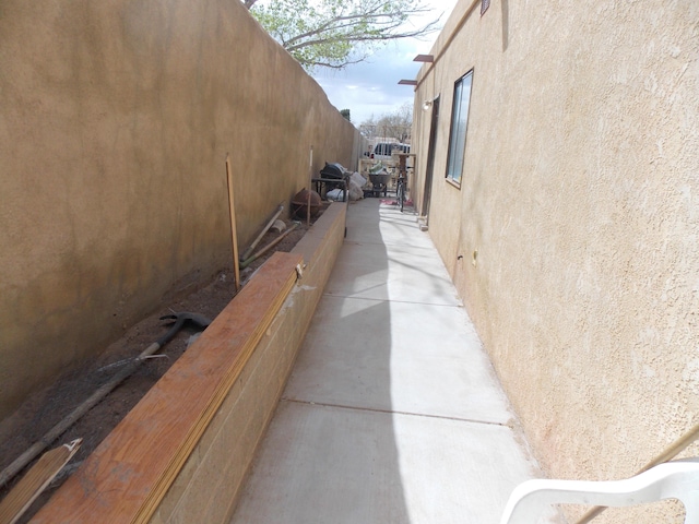 12900 Piru Blvd SE, Albuquerque, NM 87123 - view of property exterior with stucco siding and fence