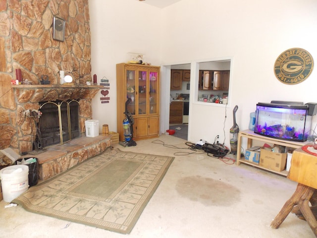 12900 Piru Blvd SE, Albuquerque, NM 87123 - living room with a stone fireplace, a high ceiling, and carpet flooring