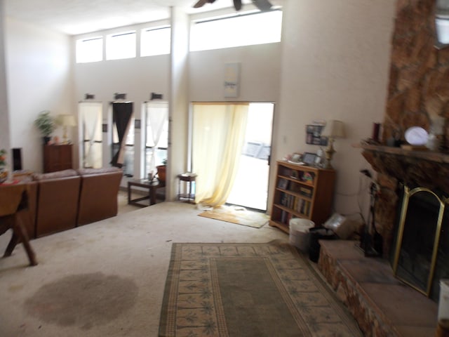 12900 Piru Blvd SE, Albuquerque, NM 87123 - carpeted living area with a ceiling fan and a fireplace