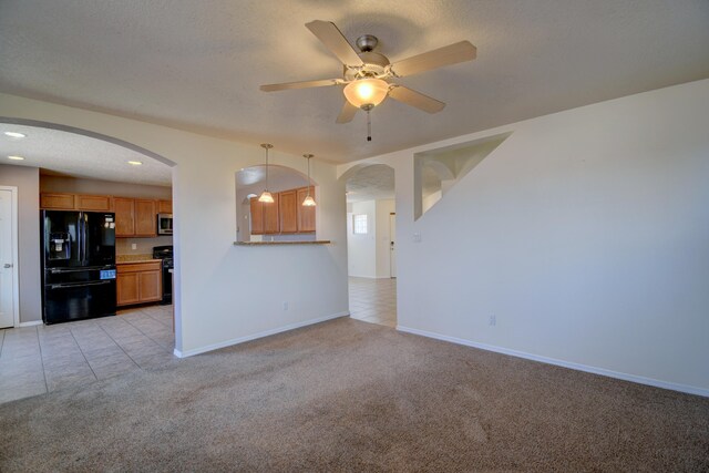 6259 Azaleas Rd NW, Albuquerque, NM 87114 - unfurnished living room with arched walkways, light colored carpet, a ceiling fan, light tile patterned floors, and recessed lighting