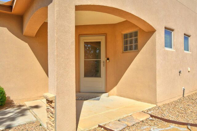 6259 Azaleas Rd NW, Albuquerque, NM 87114 - doorway to property featuring stucco siding