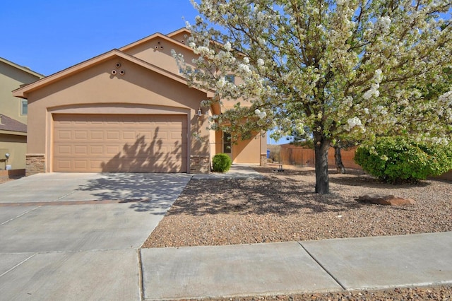 6259 Azaleas Rd NW, Albuquerque, NM 87114 - view of front of home featuring stucco siding, driveway, and a garage