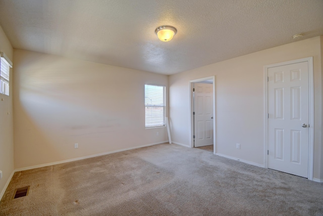 6259 Azaleas Rd NW, Albuquerque, NM 87114 - unfurnished bedroom featuring multiple windows, carpet flooring, and a textured ceiling