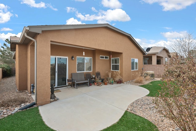 back of house featuring a patio, stucco siding, and fence