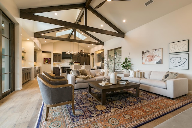 1016 Guadalupe Villa NW, Albuquerque, NM 87114 - living area with visible vents, a notable chandelier, light wood-style floors, beam ceiling, and high vaulted ceiling