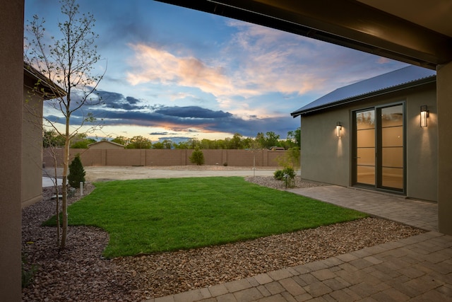 1016 Guadalupe Villa NW, Albuquerque, NM 87114 - yard at dusk featuring a patio and a fenced backyard