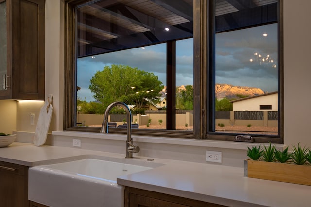 1016 Guadalupe Villa NW, Albuquerque, NM 87114 - details with dark brown cabinetry, light countertops, and a sink