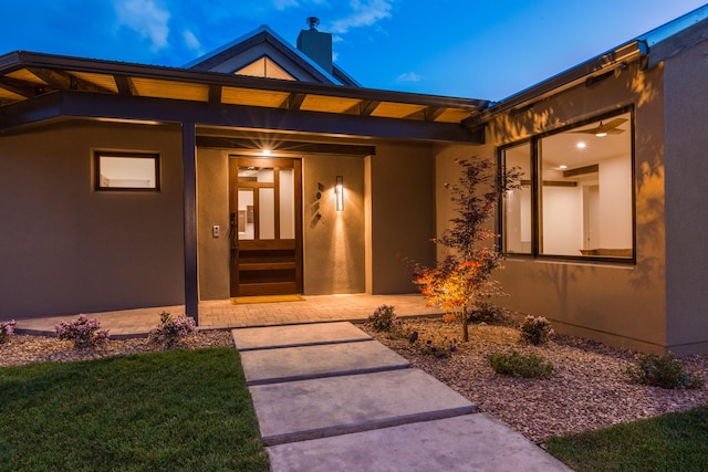1016 Guadalupe Villa NW, Albuquerque, NM 87114 - view of exterior entry featuring a chimney and stucco siding