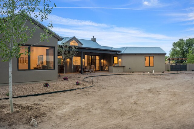 1016 Guadalupe Villa NW, Albuquerque, NM 87114 - rear view of house with metal roof, fence, and a patio