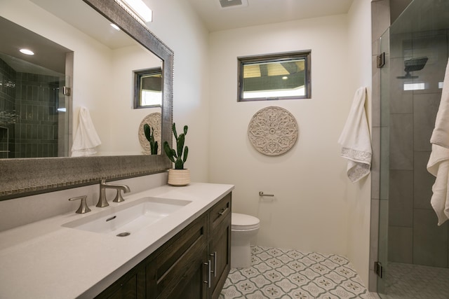 1016 Guadalupe Villa NW, Albuquerque, NM 87114 - bathroom with vanity, visible vents, toilet, a stall shower, and tile patterned floors