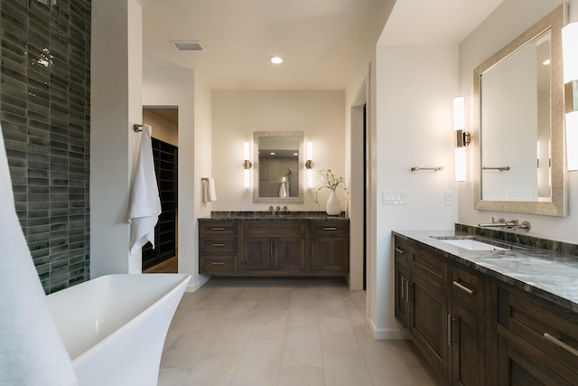 1016 Guadalupe Villa NW, Albuquerque, NM 87114 - bathroom with two vanities, a soaking tub, recessed lighting, visible vents, and a sink