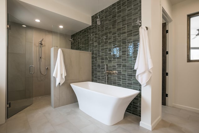 1016 Guadalupe Villa NW, Albuquerque, NM 87114 - bathroom with a freestanding bath, recessed lighting, tile walls, and a stall shower