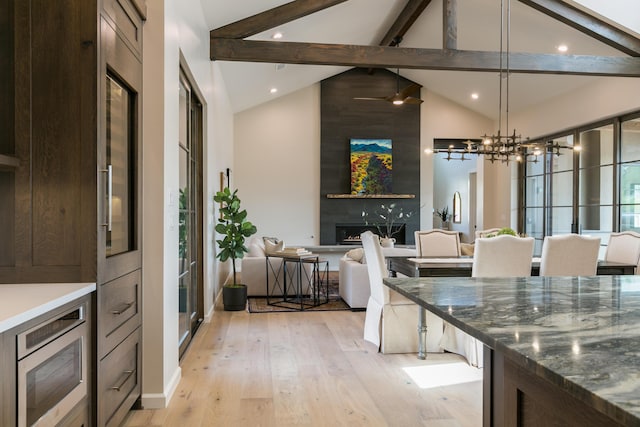 1016 Guadalupe Villa NW, Albuquerque, NM 87114 - kitchen featuring light wood-style flooring, beamed ceiling, a notable chandelier, and dark brown cabinetry