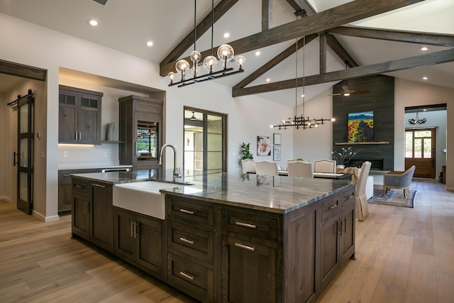 1016 Guadalupe Villa NW, Albuquerque, NM 87114 - kitchen with stone countertops, beamed ceiling, a notable chandelier, and a sink
