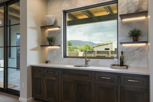 1016 Guadalupe Villa NW, Albuquerque, NM 87114 - bar featuring a sink, a mountain view, and decorative backsplash