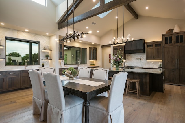 1016 Guadalupe Villa NW, Albuquerque, NM 87114 - dining room featuring light wood-type flooring, high vaulted ceiling, beam ceiling, and an inviting chandelier