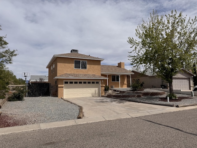 tri-level home with driveway, a garage, stucco siding, and a chimney
