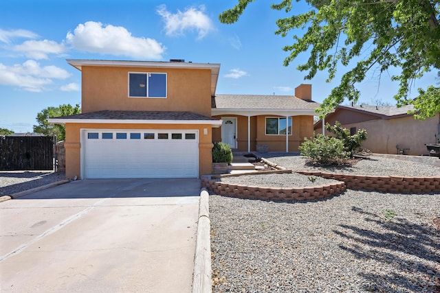 16 Apache Plume Rd, Los Lunas, NM 87031 - view of front of home with stucco siding, concrete driveway, and an attached garage