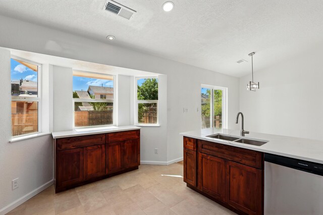 16 Apache Plume Rd, Los Lunas, NM 87031 - kitchen featuring stainless steel dishwasher, light countertops, pendant lighting, and lofted ceiling
