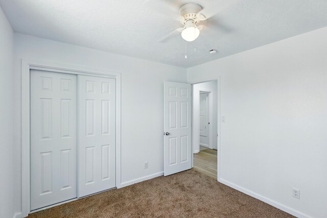 16 Apache Plume Rd, Los Lunas, NM 87031 - unfurnished bedroom with carpet floors, a closet, and a ceiling fan