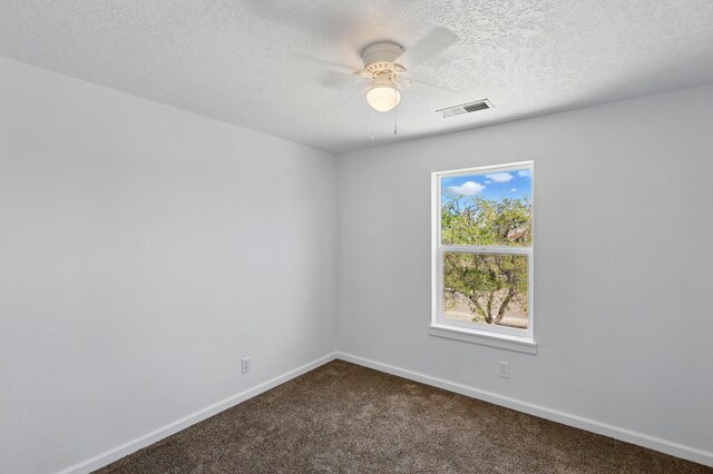 16 Apache Plume Rd, Los Lunas, NM 87031 - spare room featuring dark carpet, ceiling fan, and a textured ceiling