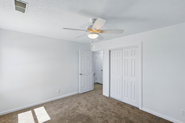 16 Apache Plume Rd, Los Lunas, NM 87031 - unfurnished bedroom with carpet floors, a closet, and a ceiling fan