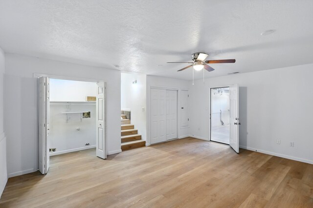 16 Apache Plume Rd, Los Lunas, NM 87031 - unfurnished bedroom with light wood-style flooring, multiple closets, and ceiling fan