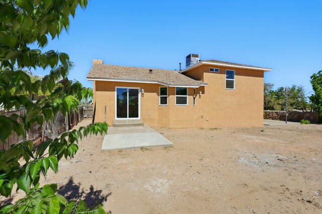 16 Apache Plume Rd, Los Lunas, NM 87031 - rear view of house with stucco siding, a fenced backyard, and a patio area