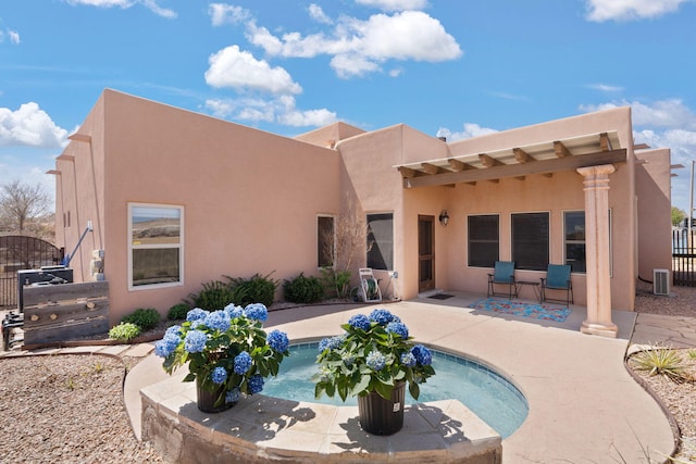 3605 Greystone Ridge Dr SE, Rio Rancho, NM 87124 - rear view of property with stucco siding and a patio
